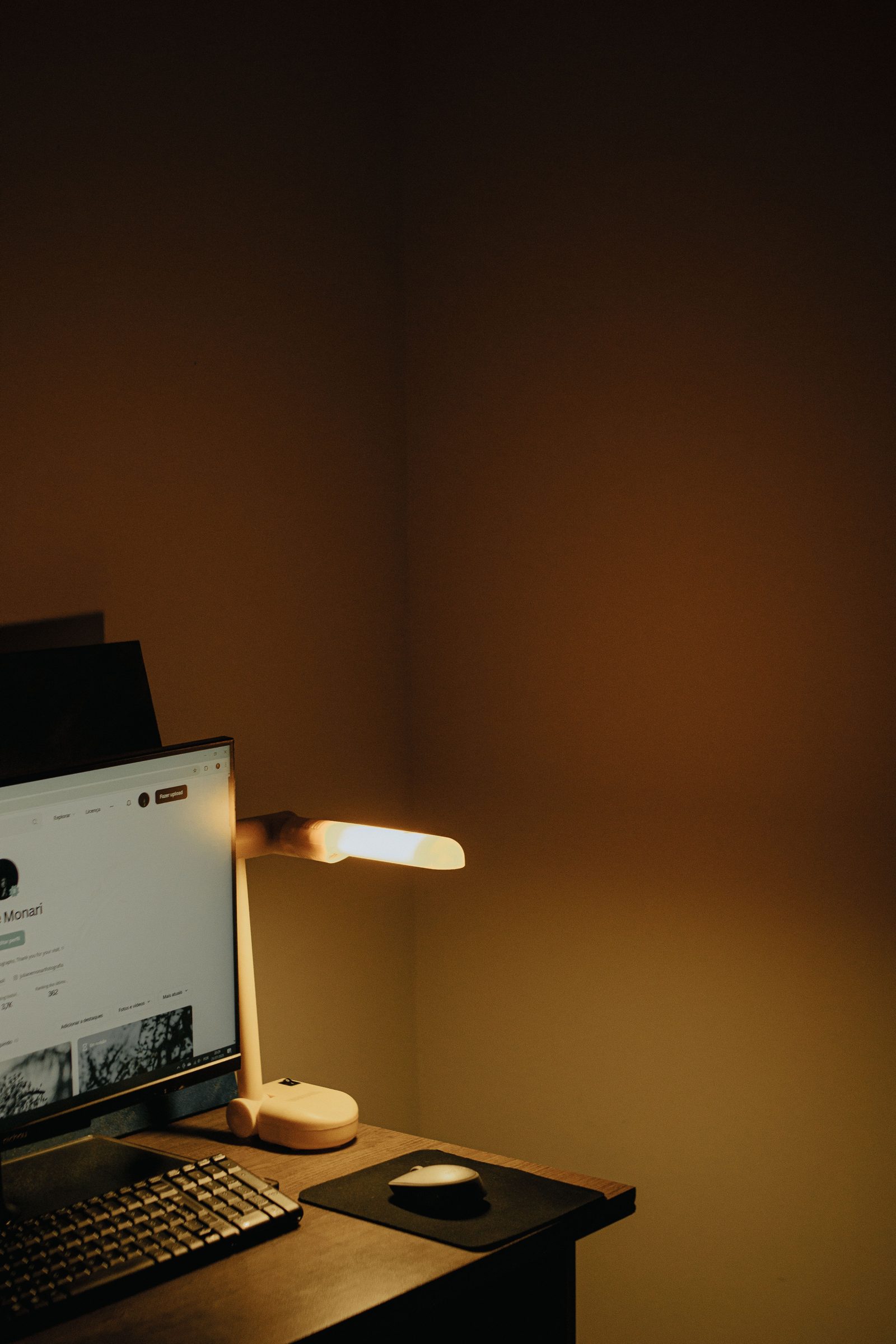 Cozy desk setup with warm lighting, photo credit juliane Monari via Pexels